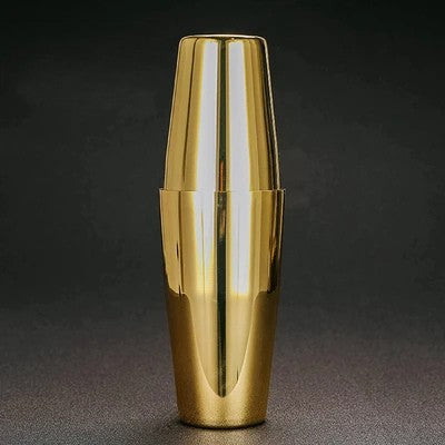 Gold cocktail shaker on a dark background