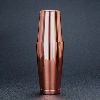 Copper cocktail shaker on a dark gray background
