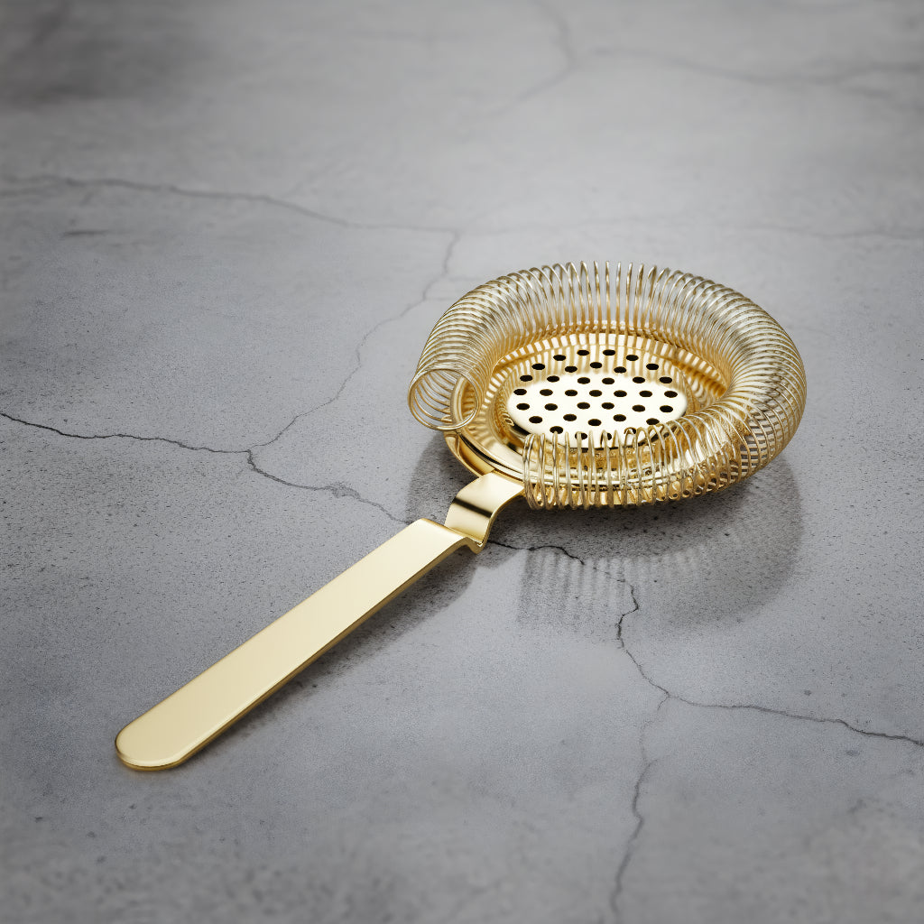 Gold mesh strainer on a gray concrete surface