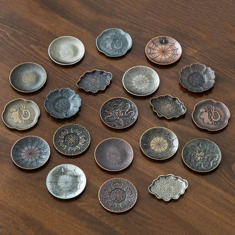 Collection of decorative ceramic plates with various patterns on a wooden surface