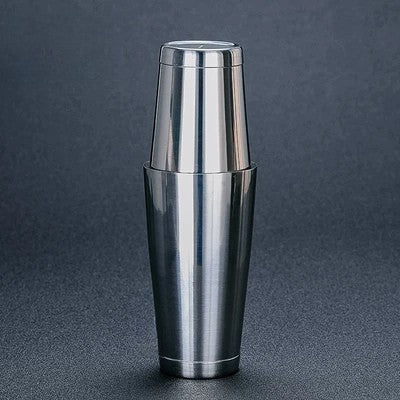 Stainless steel cocktail shaker on a dark gray background